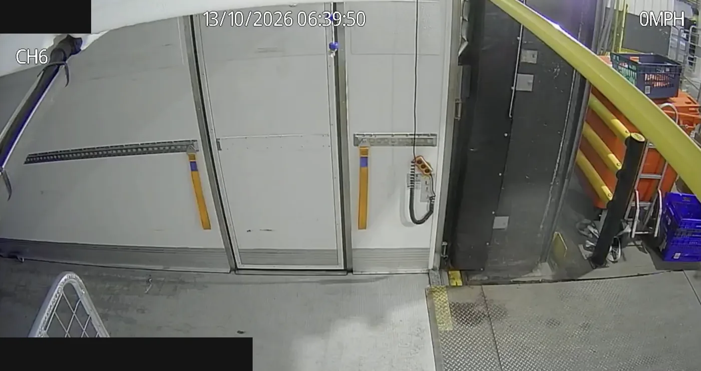 The same camera view in colour with the body open at a loading dock