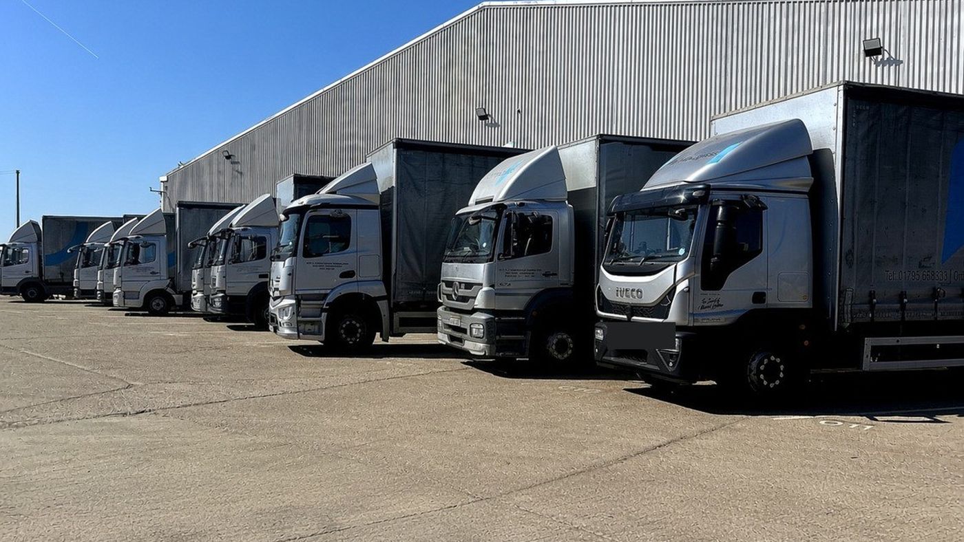 Olympic Glass curtain-side delivery lorries parked outside the company’s depot